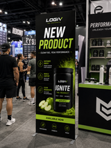 Freestanding SEG frame displays in use at a trade show booth alongside a branded counter