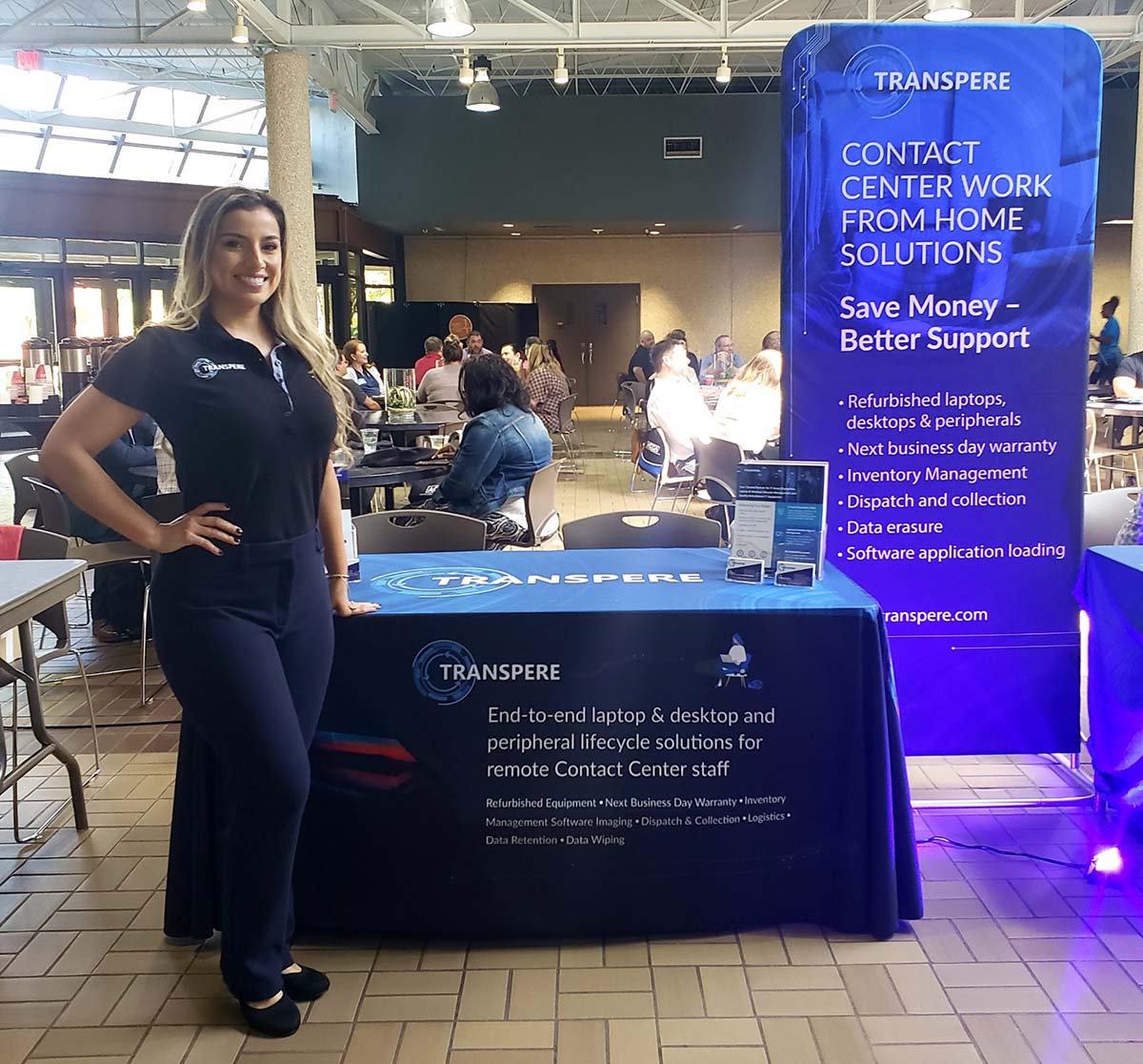 Woman standing next to a custom printed table throw at a conference 